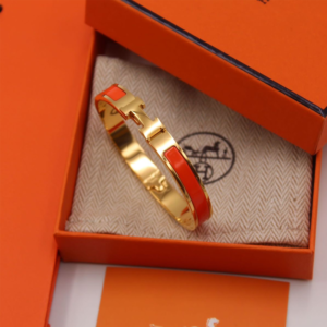 Luxury Gold-Tone Bangle Bracelet with Orange Enamel Inlay